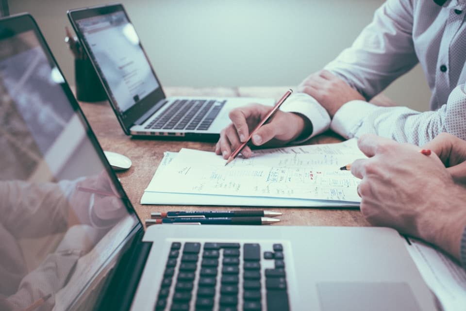 Business owner reviewing ROI and platform decisions at a desk with laptop