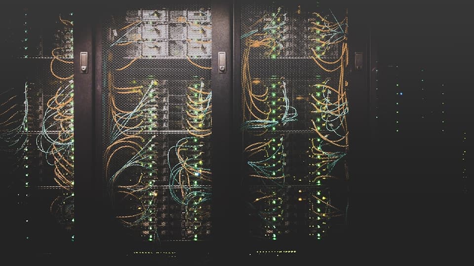 Technician walking through a datacenter server aisle