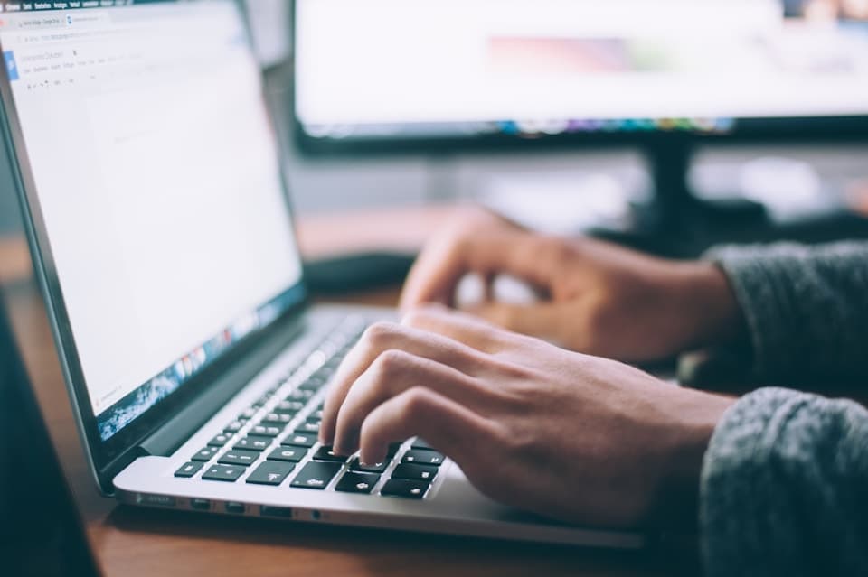 Operations leader managing multi-site client environments from laptop